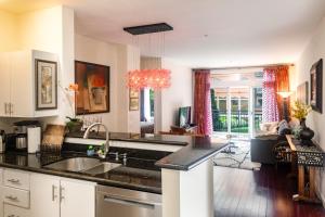 a kitchen with a sink and a living room at Cozy home nearby most attractions Seattle center in Seattle