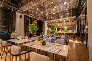 a dining room with tables and chairs and ceilings at URBN Boutique Shanghai in Shanghai