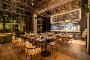 a restaurant with tables and chairs in a room at URBN Boutique Shanghai in Shanghai +36 photos