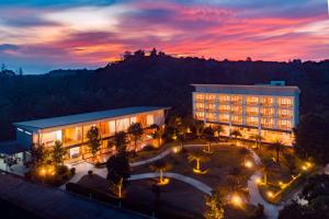 a view of a building with a courtyard at dusk at Nana Beach Hotel & Resort in Pathiu