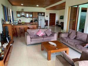a living room with two couches and a table at Lotus Villa Kandy in Peradeniya