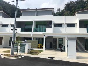 a white house with a street at 2sty Villa - Walking Distance To The Beach in Pangkor