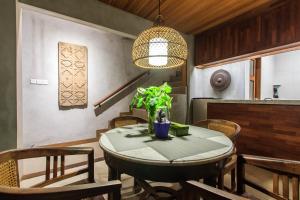 a dining room table with chairs and a pendant light at Kuta Legian Villa by Kamara in Legian