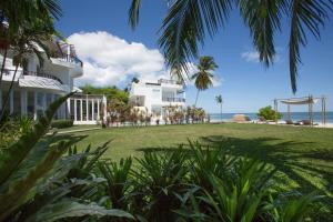 a house on the beach with palm trees at Villa Nalinnadda Petite Hotel & Spa, Adults Only in Lamai