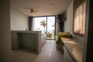 a bedroom with a bed and a view of the ocean at Kapuhala Koh Samui- Vegan Boutique Hotel in Chaweng Noi Beach +47 photos