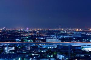a view of a city at night with lights at Miyako Hotel Amagasaki in Amagasaki