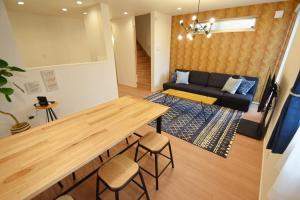a living room with a table and a couch at FINOA Residential Suite Asakusa/Oshiage Skytree in Tokyo