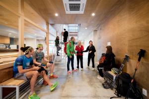 a group of people standing around in a room at Mt.Takao Base Camp in Hachioji