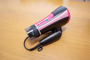 a hair dryer sitting on a wooden table at Residence Saku in Osaka