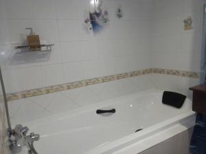 a white bath tub in a bathroom with a sink at Seaview Sriracha Hotel in Si Racha
