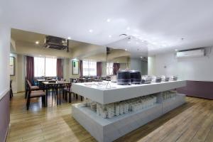 a kitchen with a counter with pots and pans at Insail Hotels ( Huanshi Road Taojin Metro Station Guangzhou) in Guangzhou