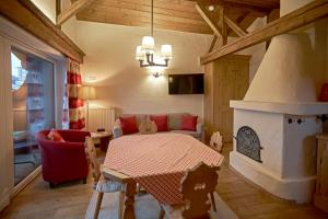 a living room with a table and a fireplace at Appartement Elisabeth in Kitzbühel