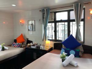 sala de estar con 2 camas y sofá en Sydney Hostel, en Hong Kong