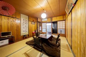 une salle à manger avec une table, des chaises et une télévision dans l'établissement Bettei Rin 別邸 凛, à Kyoto