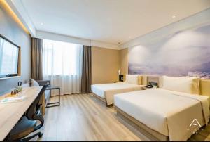 a hotel room with two beds and a desk at Atour Hotel Hefei Ma'anshan Road in Hefei