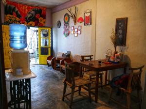 a living room with a table and chairs and a room with aperature at Omah Tukangan Homestay in Yogyakarta