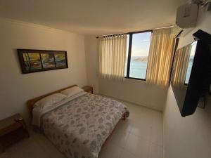 Giường trong phòng chung tại Rivas Apartamentos Santa Marta