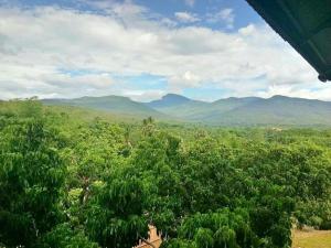 a view of the mountains from a tree line at Thanburi resort in Chom Thong