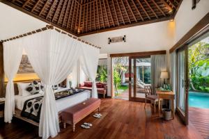 a bedroom with a bed and a pool at The Kayon Jungle Resort in Ubud