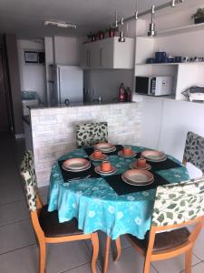 a table with plates on it in a kitchen at Localização PRIVILEGIADA Beach Class Iracema in Fortaleza