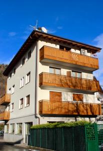 a building with wooden balconies on top of it at B&B Penak Mountain wellness in Aprica
