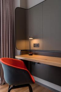a desk and a red chair in a room at Holiday Inn Express Chiayi, an IHG Hotel in Chiayi City