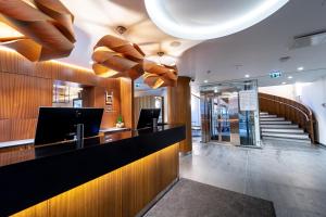 a lobby with a reception desk and a staircase at Hestia Hotel Kentmanni in Tallinn