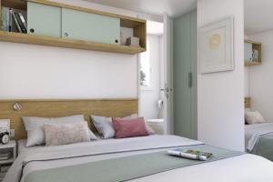 a bedroom with a large white bed with a bottle on it at Camping Torre Castiglione in Torre Lapillo +58 photos