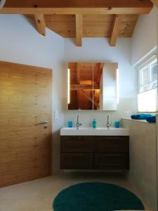 a bathroom with a sink and a mirror at Eddy ´s Panorama Suite in Stanzach