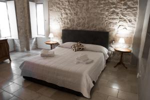 a bedroom with a large bed with two tables at Graffiti Living - Santa Rita - Rooms in Corato