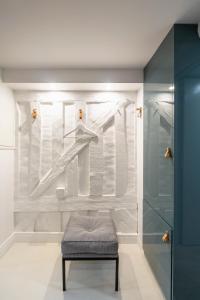 a bathroom with a bench and a wall with towels at Ty Color's in Rennes +33 photos