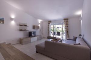 a living room with a couch and a tv at Charming villa Manuela with wonderful pool near the beach in Banjole