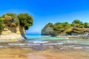 a view of a beach with rocks and the ocean at Takis Apartments in Sidari