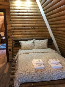 a bedroom with a bed with two towels on it at Belvedere Villas in Dospat