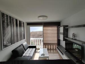 ein Wohnzimmer mit einem Sofa und einem Tisch in der Unterkunft Apartamento Playa Quemada Lanzarote in Playa Quemada
