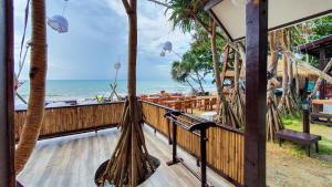 a resort balcony with a view of the beach at New Harrys Sunset Resort - Klong Nin Beach in Ko Lanta