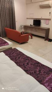a hotel room with a bed and a couch at Rural Area Hotel in Wanqiao