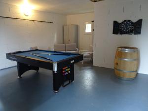 a ping pong table in a room with a barrel at LV Holidays 2 in Savigny-en-véron