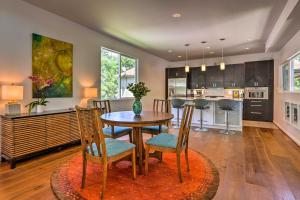 a kitchen and dining room with a table and chairs at Mod Austin House with Deck, Yard and Walkable Location in Austin