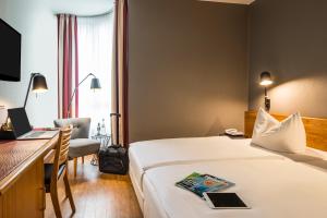 a hotel room with a bed and a desk at Mercure Hotel Berlin Zentrum Superior in Berlin +44 photos