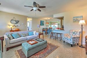 a living room with a couch and a table at Ormond Beach Bungalow with Patio and Quiet Setting! in Ormond Beach