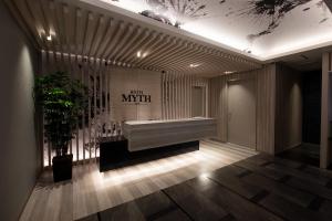 a lobby with a bench in the middle of a room at HOTEL MYTH-WA -ホテル マイス ワ- adult only in Wakayama +43 photos