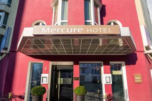 a red building with a sign that reads mercure hotel at Mercure Hotel Berlin Zentrum Superior in Berlin