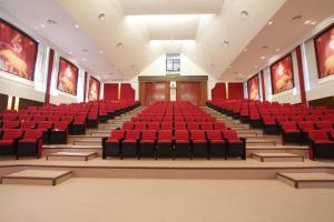 an empty auditorium with red seats in a building at The Thai Elephant Conservation Center Lampang in Lampang