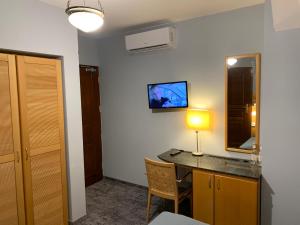 a room with a desk with a lamp and a mirror at Hotel Willa Starosty in Międzyrzecz