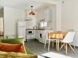 a kitchen and dining room with a table and chairs at The Blue Corner Apartments in Puerto de la Cruz