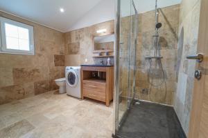 La salle de bains est pourvue d'une douche et d'un lave-linge. dans l'établissement LES VALLEES by Cocoonr, à Bonnefamille