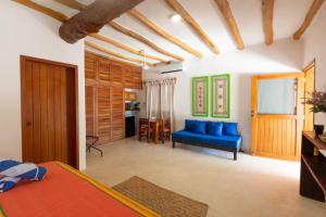 a bedroom with a blue couch and a blue couch at La Casa del Alux - Adults Only in Holbox Island