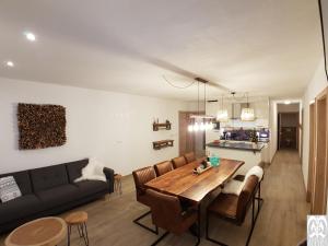 a living room with a couch and a wooden table at DAVID SUITEN in Mauterndorf