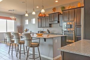 a kitchen with a large island with bar stools at Gorgeous Litchfield Oasis about 6 Mi to Luke AFB in Litchfield Park